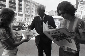 Boston Phoenix promotional photos: Phoenix hawker handing paper to man, Stephen Davis (r) reading