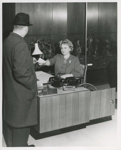 Mrs. Frances Marsala seated in her wheelchair working as a receptionist