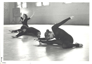 Three female dancers stretching