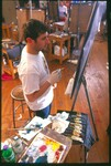 A Suffolk University student paints at an easel during a NESAD painting class, photograph, Spring 2003