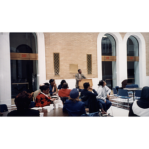 A man speaks at a lectern at a town hall meeting