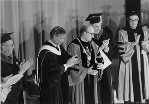 Robert C. Wood with a group of men in during his installation into office