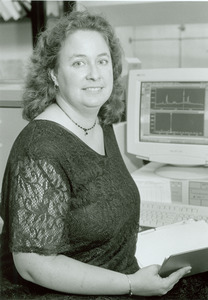 Emily CoBabe standing by a computer