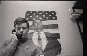 Young Americans for Freedom (YAF) office: YAF member talking on the phone in front of poster of William F. Buckley