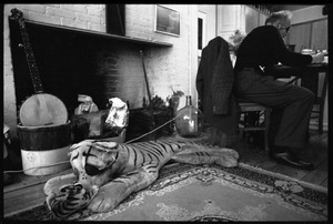 W. Eugene Smith, seated at a desk in his home