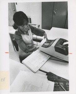 Lillian Rowe uses an adding machine at TOWER clerical training