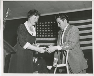 Unidentified woman handing gift to client at Institute Day