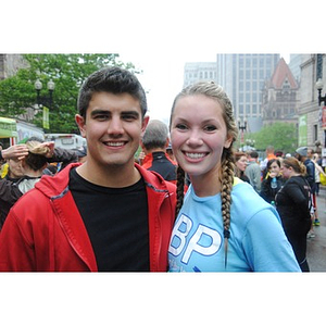 Young man and woman take photo at One Run finish line by Copley Square
