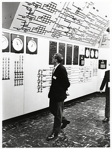 Unidentified man viewing gauges, likely at a military base