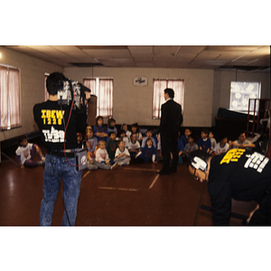 IBEW television crew filming man addressing children at the Eastern Middlesex Family YMCA