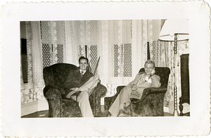 Manny Dias and friend sitting on chairs