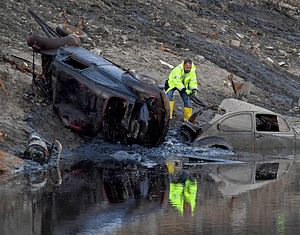 A workman preparing a vehicle to be removed from Lake Massasoit (2020)