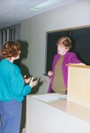 Suffolk University Professor Catherine T. Judge (Law) speaking with student in classroom, photograph, circa 1990s