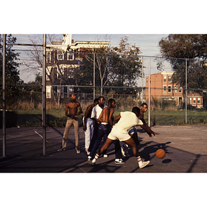 Boys playing basketball outside