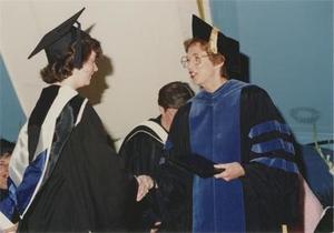 President Alice F. Emerson Grants Student Diploma.