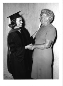 Two women shake hands at the 1970 Suffolk University commencement
