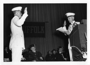Suffolk University student in a Navy uniform taking an oath at the 1969 commencement