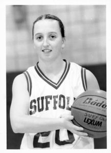 Suffolk University women's basketball player Kate Norton (#20), posed holding basketball, circa 1999