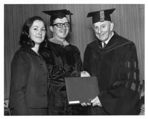 James Griffin, with wife Kathy Griffin, receives diploma from President John E. Fenton (1965-1970) at the 1970 Suffolk University commencement
