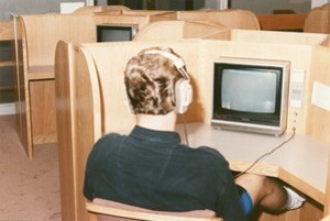 O'Neill Library interior: student with headphones looking at screen