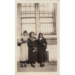 Three women in overcoats