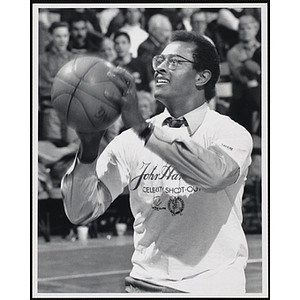 Boston television personality Lester Strong shooting a basketball at a fund-raising event held by the Boys and Girls Clubs of Boston and Boston Celtics