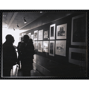 Several men and women view the Boys' Clubs of Boston Tri-Club Art Exhibit at the Museum of Science