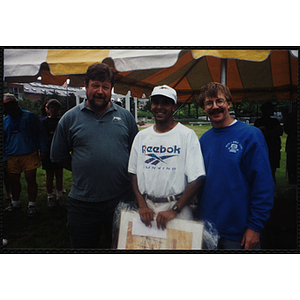 Charlestown director Jerry Steimel (right) poses with two men during the during the Battle of Bunker Hill Road Race