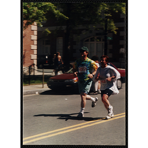 A woman and a man run in the Battle of Bunker Hill Road Race