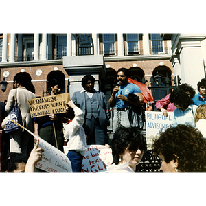 Man speaks in favor of bilingual education on the steps of the Massachusetts State House