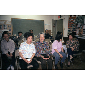 Association members smile for the camera as they wait for an event to begin