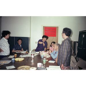 Suzanne Lee cuts a cake at her birthday celebration