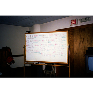 Whiteboard with the Chinese Progressive Association's election results written in Chinese and English