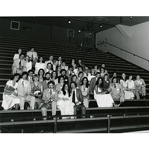 Alumni sit together on bleachers at their Class of 1973 Five Year Reunion