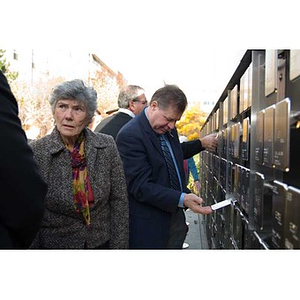 A man looks at a plaque on the Veterans Memorial at the dedication