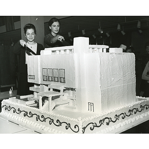 Students cut cake at the dedication ceremony for the addition to the Ell Student Center