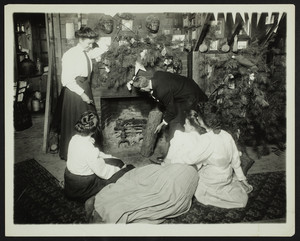 One man and four women in front of a fireplace, location unknown, undated