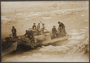 Men working on a barge in the icy waters of the Cape Cod Canal during its construction.