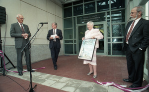 Dedication ceremonies for the Conte Polymer Center: Corinne Conte holding a plaque, David K. Scott and John Olver in background