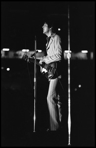 Paul McCartney (the Beatles) playing bass and singing in concert at D.C. Stadium: full-length portrait