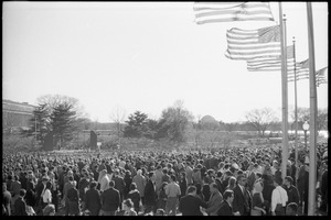 Crowd of demonstrators under American flags on the National Mall, Jefferson Memorial in the distance: Washington Vietnam March for Peace