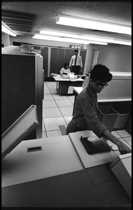 Computer room scene: woman operating a Hollerith card machine (?) with Honeywell Model 400 mainframe units in background