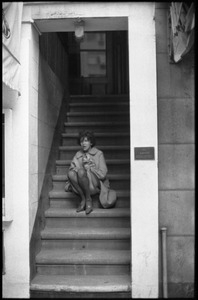 Woman sitting in a stairwell of a New York building, during the Vietnam Moratorium activities