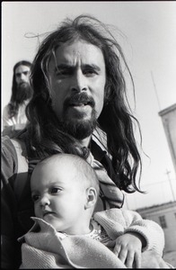 Hollywood Speedway Rock Festival: long-haired man holding infant