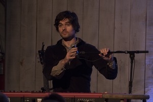 Matt Nakoa (keyboards) adjusting his microphone during a concert at the Payomet Performing Arts Center