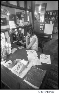 Receptionist at her desk, Erewhon Food Coop warehouse, Farnsworth Street