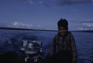 Boy steering outboard motor