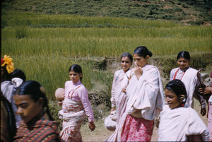 Women walk down rural road