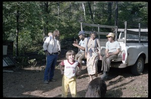 Communards seated on the back of a pickup truck, awaiting a hike, Montague Farm commune