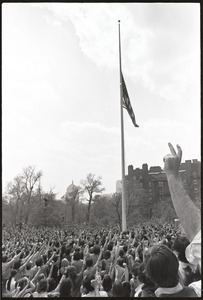 Demonstration at State House against the killings at Kent State: protesters raising fists at lowering of American flag on Boston Common